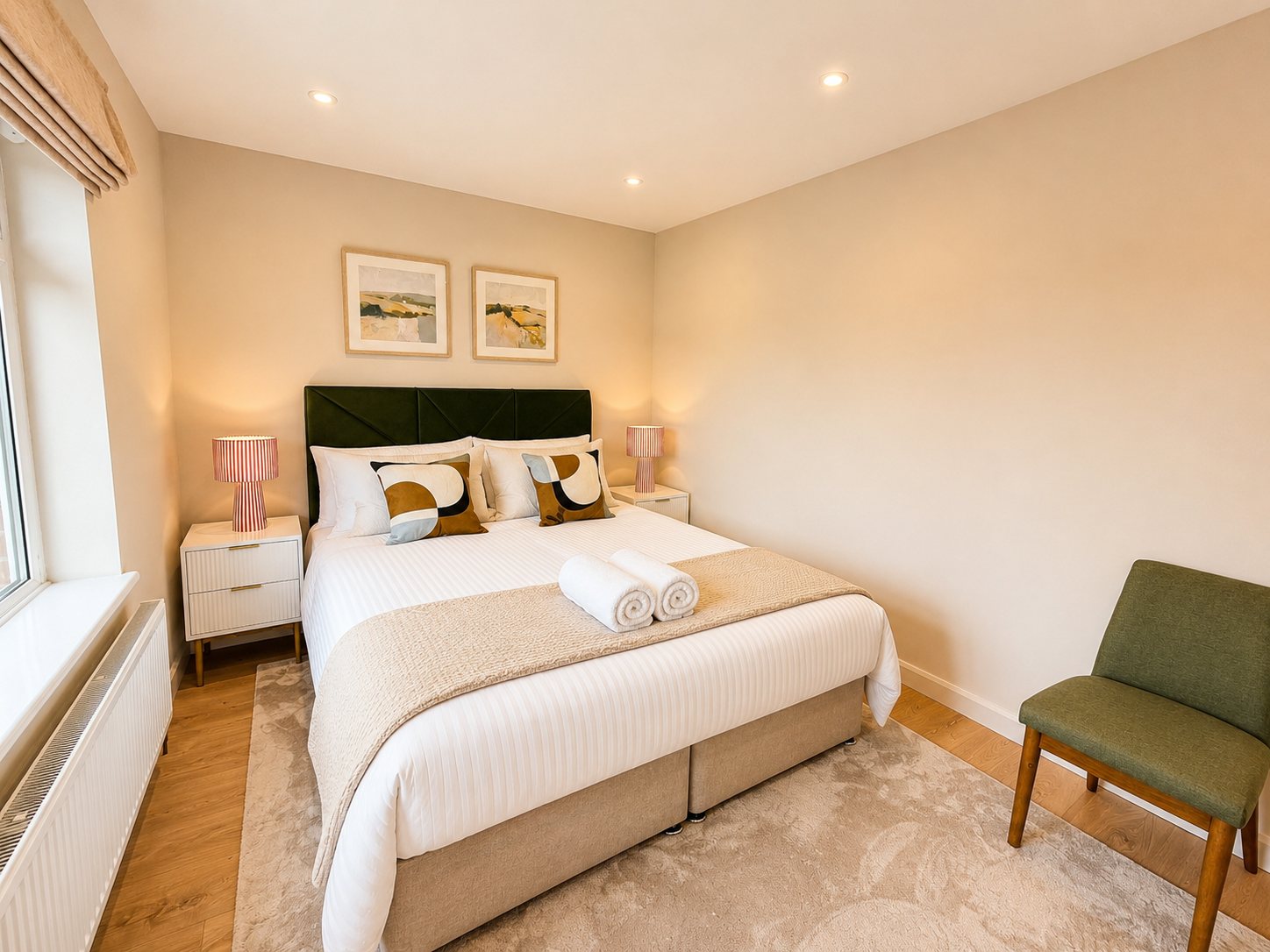 Second king-size bedroom with soft neutral colours and lamps